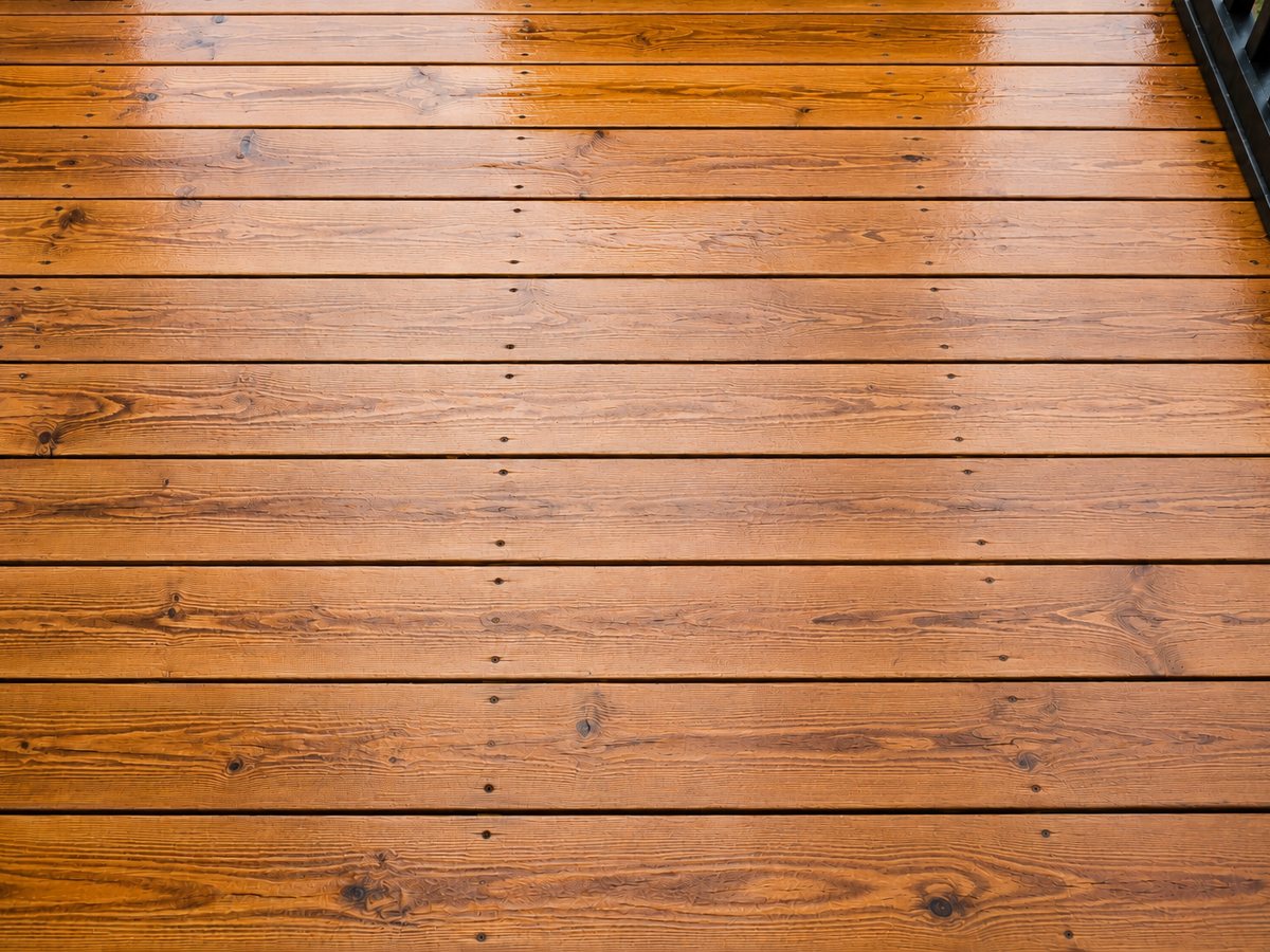 A warm, sunlit wood deck freshly restored by soft-washing